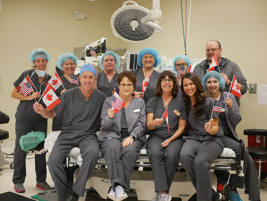 Group of Our Doctors Holding USA and Canadian Flags